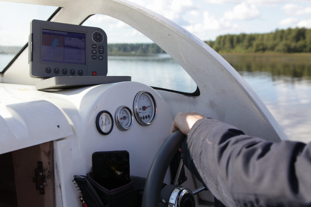 man at the main controls of a boat