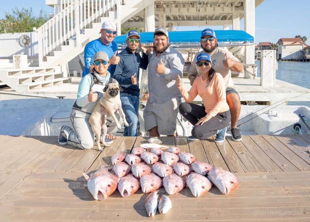 a family poses with a collection of red snapper caught in texas